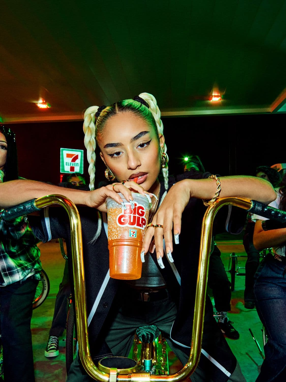 Girl sitting in the back of a car, surrounded by cartoon characters, laughs while looking through the car window