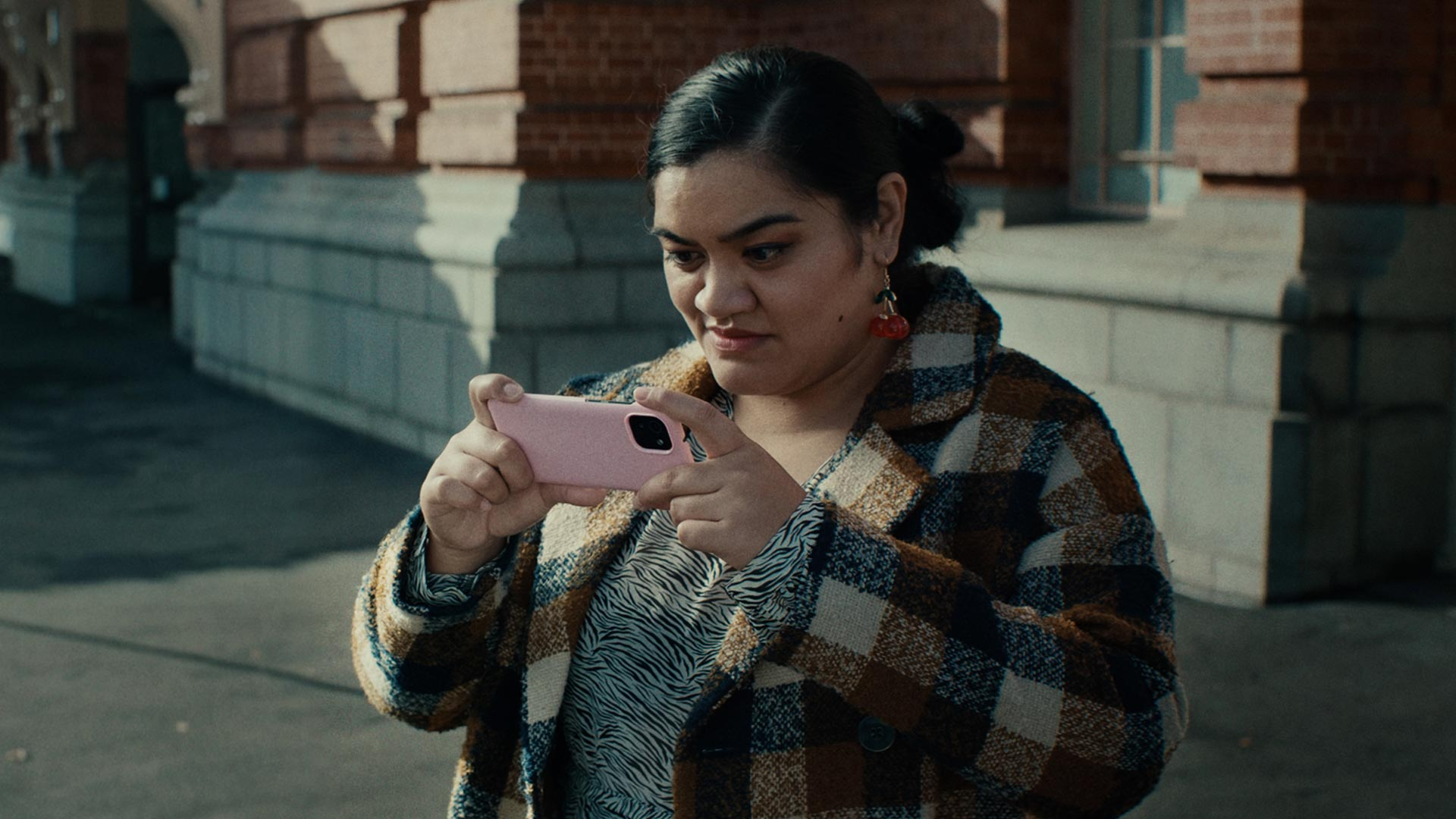 TVNZ Movie Still of Woman taking picture with I-phone