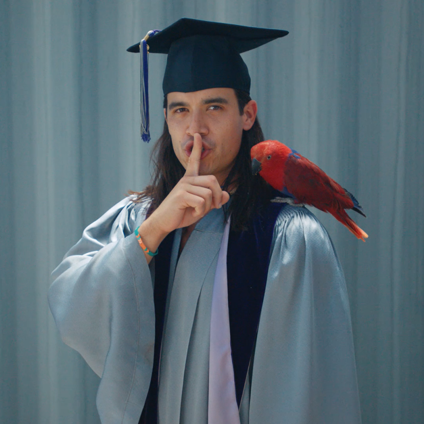 Graduation "shush" pose with parrot on shoulder